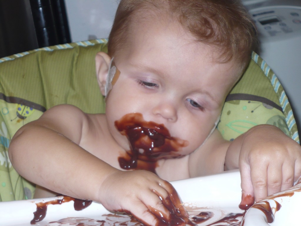 Baby plays in pudding