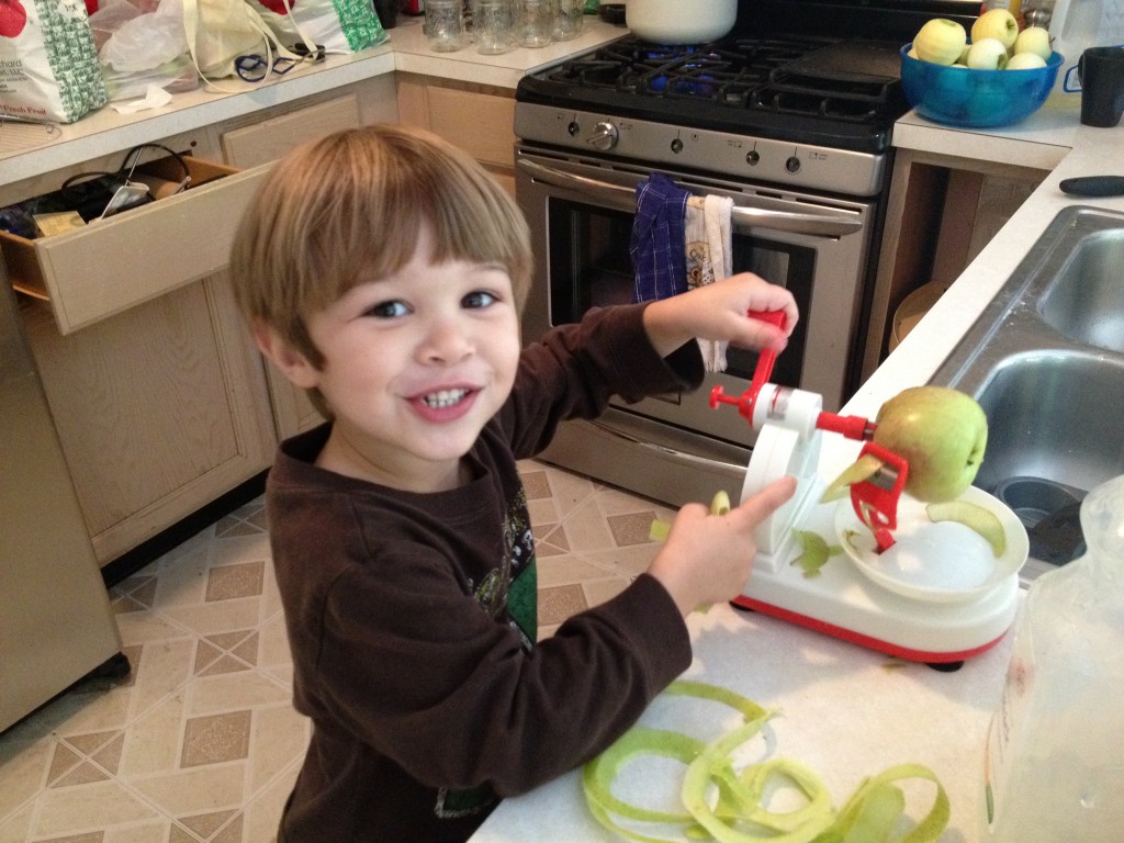 Boy peeling apples