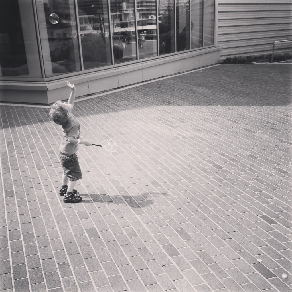 boy chasing bubbles