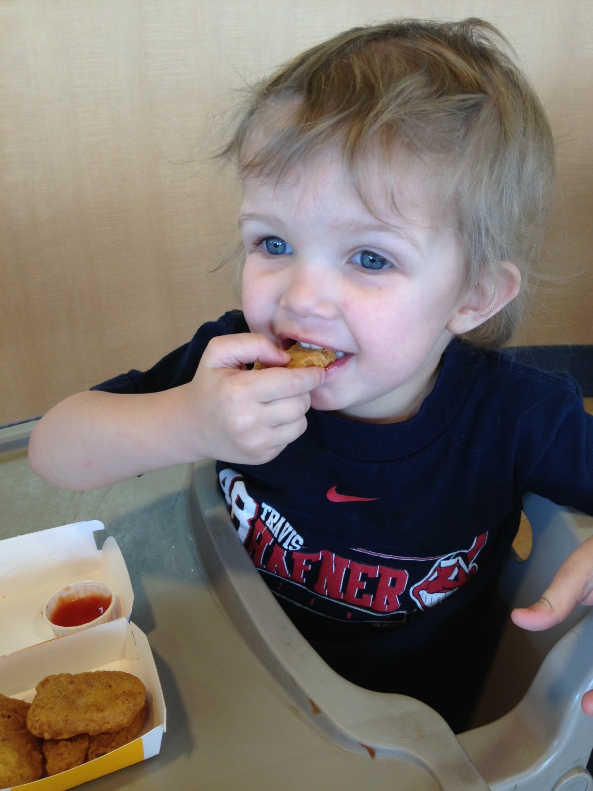 kid eating chicken nuggets